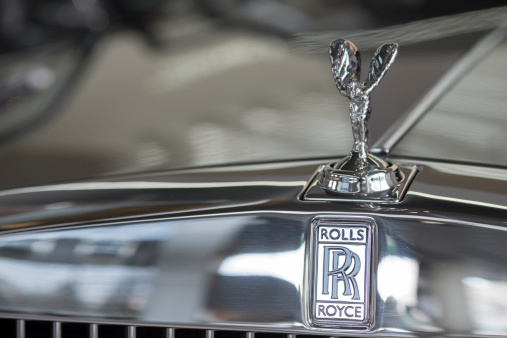 Munich, Germany - November 5, 2013: The hood of a Rolls Royce with the Spirit of Ecstasy parked in front of the BMW Welt. Rolls Royce Cars Limited is a wholly subsidiary of BMW founded in 1906 .