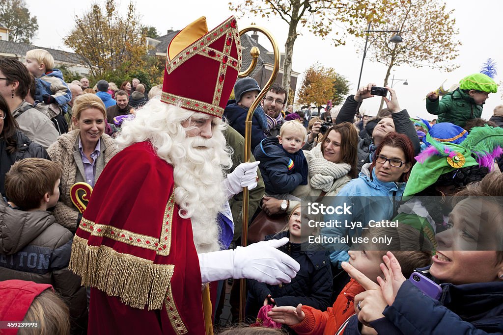 Arrival of Sinterklaas  5 XXL Zaltbommel, the Netherlands - November 16, 2013: The arrival of Sinterklaas in the city of Zaltbommel. Sinterklaas and Zwarte Pieten walking in the streets of Zaltbommel. On the picture Sinterklaas has just arrived by boat from Spain, together with his helpers called Black Petes. Sinterklaas is a winter holiday figure, it's believed that Sinterklaas brings children presents in the evening of the fifth of December. The arrival of Sinterklaas is always somewhere mid november and also celebrated in many places throughout the country. Sinterklaas Stock Photo