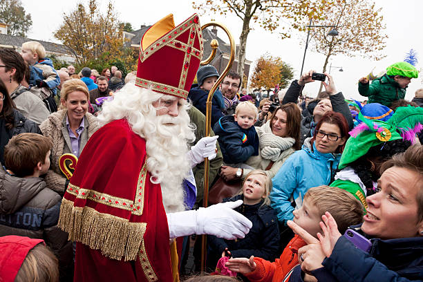 Arrival of Sinterklaas  5 XXL Zaltbommel, the Netherlands - November 16, 2013: The arrival of Sinterklaas in the city of Zaltbommel. Sinterklaas and Zwarte Pieten walking in the streets of Zaltbommel. On the picture Sinterklaas has just arrived by boat from Spain, together with his helpers called Black Petes. Sinterklaas is a winter holiday figure, it's believed that Sinterklaas brings children presents in the evening of the fifth of December. The arrival of Sinterklaas is always somewhere mid november and also celebrated in many places throughout the country. zwarte piet stock pictures, royalty-free photos & images