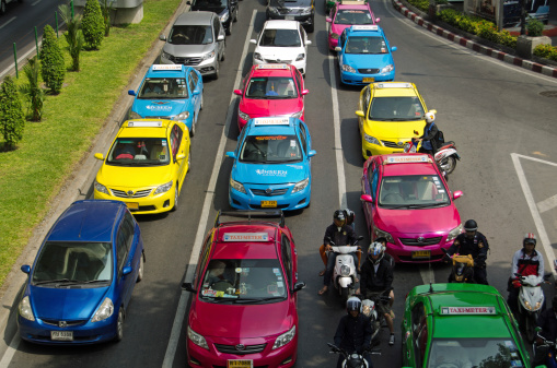 Bangkok, Thailand - October 26 2013:  Colourful taxis in central Bangkok queuing in a traffic jam.