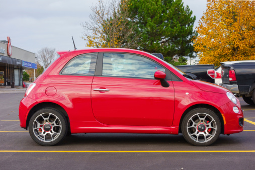 Hamilton, Canada - November 7, 2013: Red colored Fiat 500 city car parked in a parking lot.