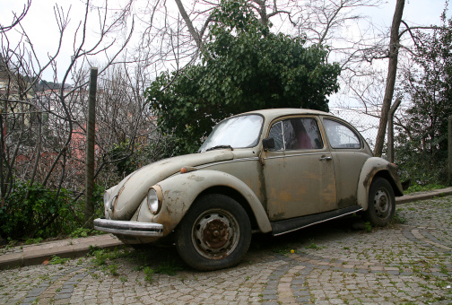 Istanbul, Turkey - April 9, 2011: Old fashioned damaged car parked on istanbul old town street. The Volkswagen Type 1, widely known as the Volkswagen Beetle, was an economy car produced by the German auto maker Volkswagen (VW) from 1938 until 2003.