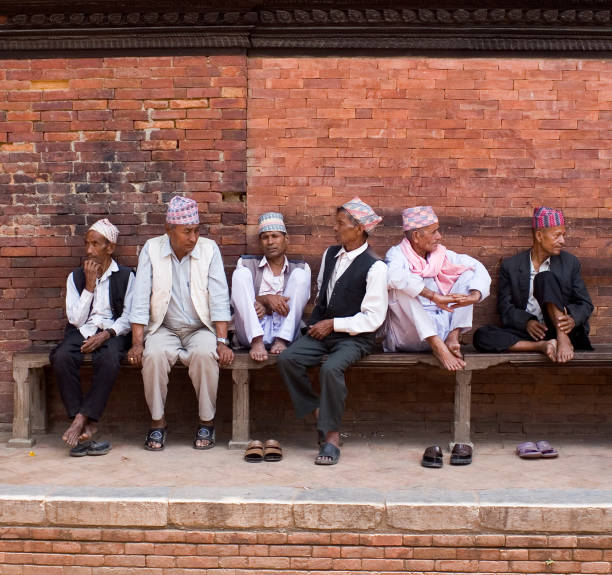 Patan, Nepal - May 09, 2008: Group of Nepalese men discussing news on the street.