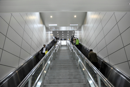 Shanghai, China - November 19, 2010: Commuters using escalator in the Metro of Shanghai, China