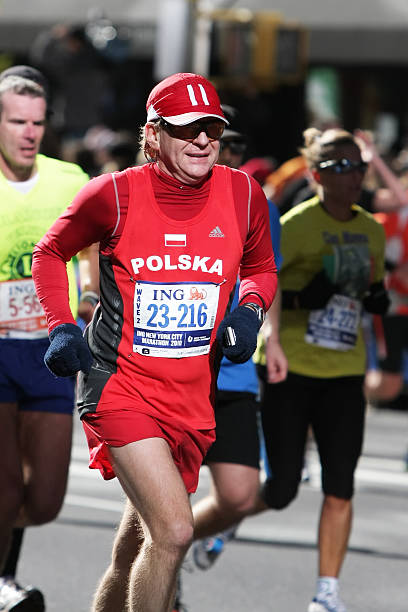 New York City Marathon New York City, USA - November 07, 2010: Athlete from Poland running during the 2010 ING New York City Marathon. new york marathon photos stock pictures, royalty-free photos & images
