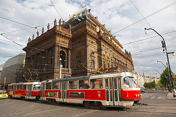 Prague, Czech Republic - May 9, 2012: The driver of tram 7001/7002 keeps his eye on busy traffic as he passes Pragueaas National Theatre on NA!rodnA- heading for Most legii.  He is travelling on the scenic Route 22 that also passes Prague Castle.  Pragueaas 500km tram network serves more than 300 million passengers each year along 22 routes.