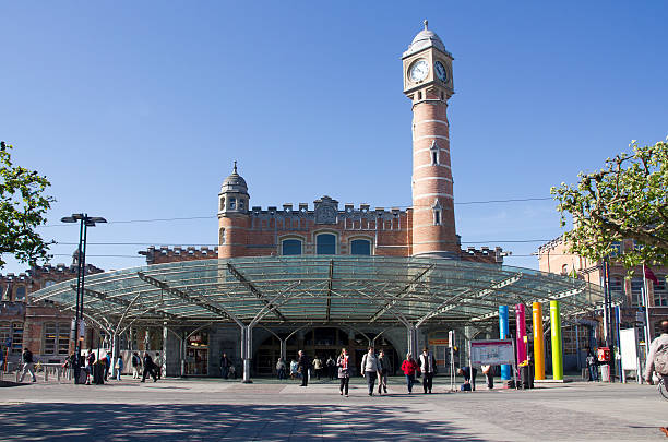 Ghent, Belgium - May 3, 2011: Railway station of Ghent, Belgium, with train travelers leaving the building on May 3, 2011