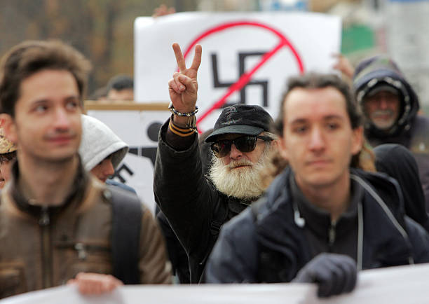 Sofia, Bulgaria - November 17, 2013: An elderly man shows peace sign during march in the streets of Sofia in anti fascist protest in central Sofia.
