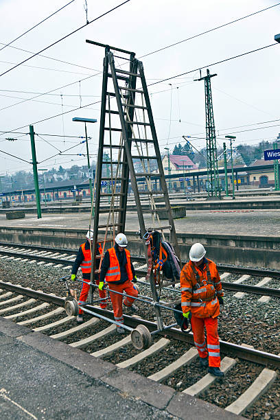 travailleur réparation le catenary - editorial safety in a row industry photos et images de collection