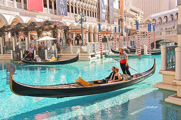 Gondola rides in Venetian Hotel . Las Vegas Las Vegas, Nevada, USA - October 20, 2013: Gondola rides in Venetian Hotel in Las Vegas, The resort opened on May 3, 1999. One of the most luxurious hotels in Las Vegas gondolier stock pictures, royalty-free photos & images