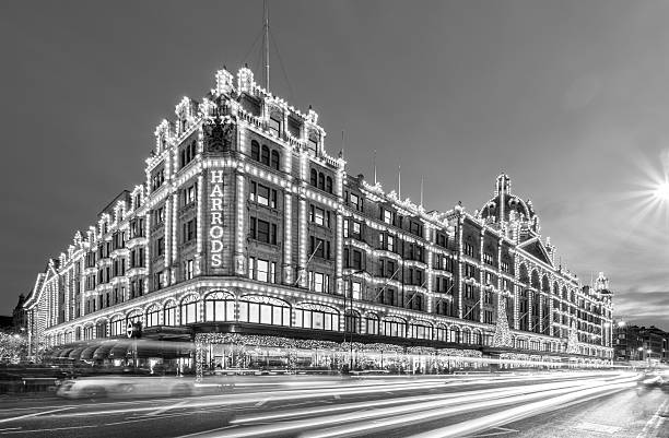 London, Harrods department stores at night in black & white London, United Kingdom - November 01, 2013: The Harrods department stores in London's Knightsbridge at blue hour, with traffic and passengers passing by in blurred motion. harrods photos stock pictures, royalty-free photos & images