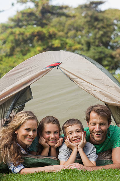 istock Cheerful family smiling while lying in their tent 459247133