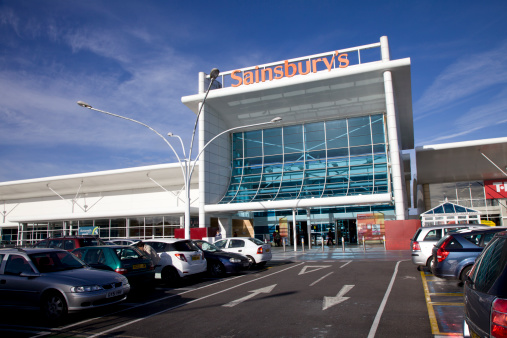 Bournemouth, England - October 15th 2012: Sainsburys Supermarket on a bright sunny autumn morning with the car park directly in front. Located at Castlepoint shopping centre in Bournemouth, south coast of England. Sainsburys is the third largest supermarket chain in the UK after Tesco and Asda. But more upmarket. 