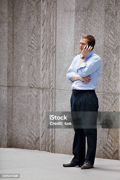 Businessman Standing Against A Concrete Wall Stock Photo - Download Image Now - 2011, Adult, Adults Only