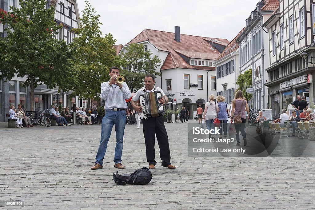 Street musicians on German market square "Soest, Germany - August 6, 2011 : Two Street musicians making music on the Market square in the historic downtown area of Soest, Germany on a summer day in August, 2011." Germany Stock Photo