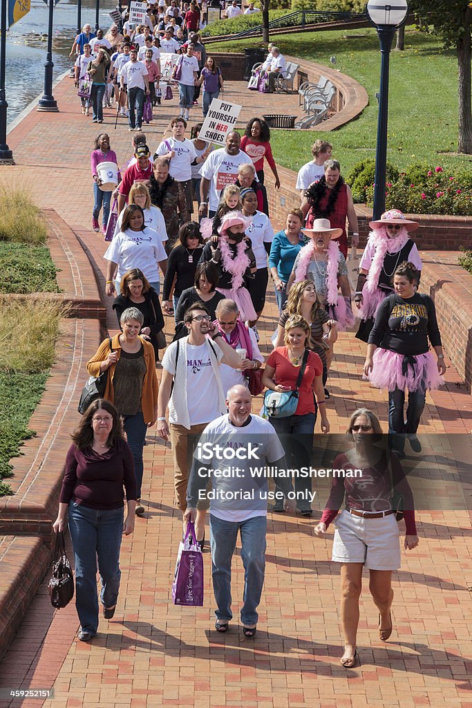 Walk a Mile In Her Shoes--Event Against Domestic Violence "Frederick, MD, USA - October 6, 2012: People near the end of a one mile walk to raise money to help fight domestic violence. This was the third annual Walk a Mile In Her Shoes event to benefit Heartly House. This non-profit organization provides resources to victims of domestic violence. In the event, over 150 men put on women's high heel shoes and walked a mile to show their support for the fight against domestic violence." Annual Event Stock Photo