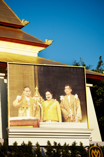 Chiang Mai, Thailand - December 14, 2011: Large photograph in a public place of King Bhumibol Adulyadej, Queen Sirikit and Prince Maha Vajiralongkorn. The royal family in Thailand are very well respected by the Thai people and images of them in public places are common.