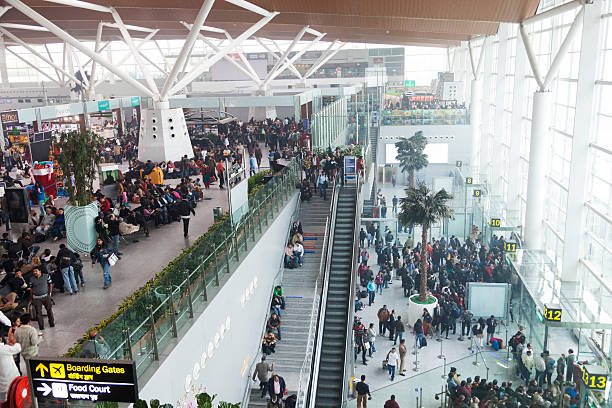 New Delhi Indira Gandhi airport "New Delhi, India - December 30, 2011: A lot of people inside the domestic departure terminal at New Delhi airport. In winter there is fog almost every day and almost all domestic flights are delayed for many hours." india airport stock pictures, royalty-free photos & images