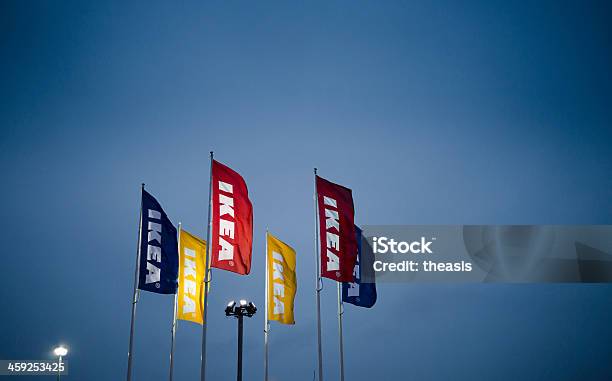 Ikea Flags At Night — стоковые фотографии и другие картинки Ikea - Ikea, Великобритания, Флаг