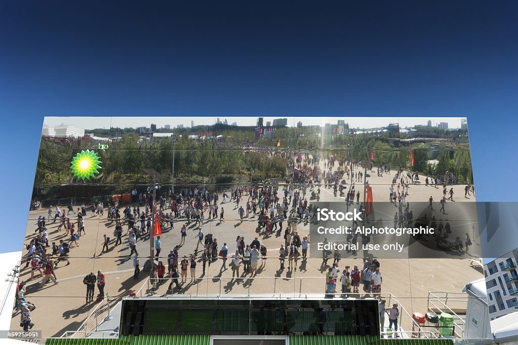 London Olympics BP Building Modern Architecture "London, England - September 7, 2012: London Olympics BP venue. This is a view of the angled frontage against a deep blue sky, it shows the clean mirrored lines and the styling of this unique building together with the BP logo and the reflection of the visitors who pass in front of it." 2012 Stock Photo