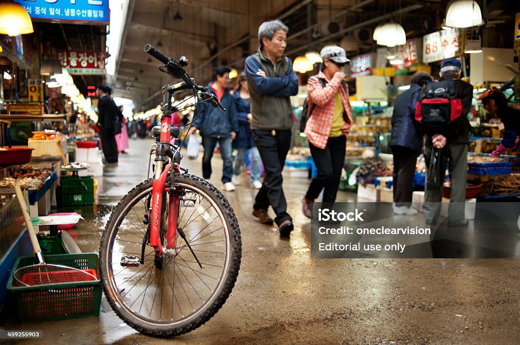 Noryangjin Fisheries Wholesale Market Seoul, South Korea - April 9, 2012: Noryangjin Fisheries Wholesale Market, People shopping at the Noryangjin Fisheries Wholesale Market. Many of the vendors use bicycles to travel around the market.; The seafood market covers an area of over 66; 000 square meters and has over 700 shops and is open 24 hours a day. Asia Stock Photo