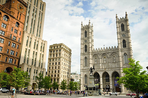 Place d'Armes with Notre-Dame Basilica in Montreal, Quebec "Montreal, Canada - August 23, 2012: People mill about in the Place d'Armes in Old Montreal next to the Notre-Dame Basilica and Maisonneuve Monument." place darmes montreal stock pictures, royalty-free photos & images