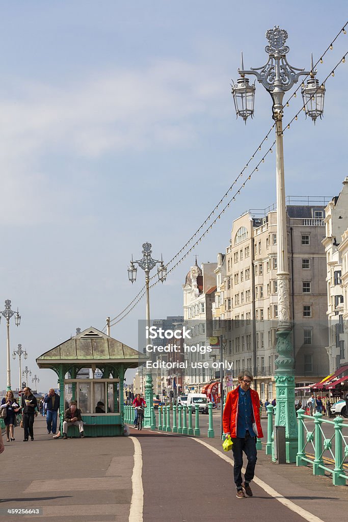 The Grand Hotel, Brighton, England "Brighton, United Kingdom - May 5, 2011: People can be seen walking on a waterfront walkway along the coast at Brighton. Regency style buildings can be seen in the background." Architecture Stock Photo