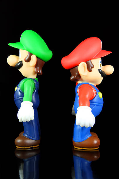 Brothers Backs "Vancouver, Canada - October 4, 2012: Luigi and Mario from the Nintendo Super Mario franchise of games, posed against a black background. The toys are from Banpresto Company." named animal stock pictures, royalty-free photos & images
