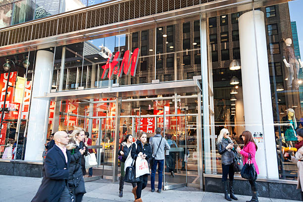 H&M New York City # 1 "New York City, USA - December 13, 2012: People walking and talking in front of the H&M Department store at the intersection of 42nd Street and 5th Avenue in New York City." h and m stock pictures, royalty-free photos & images