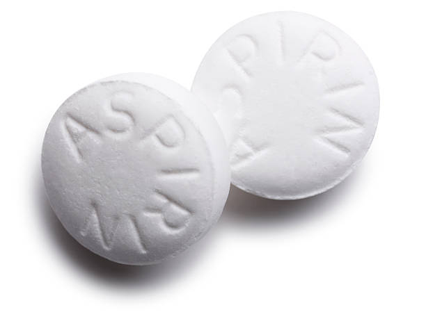 Aspirin Pills Isolated on White "San Diego, California, USA - January 14, 2009:  Two Aspirin pills isolated on white." aspirin photos stock pictures, royalty-free photos & images