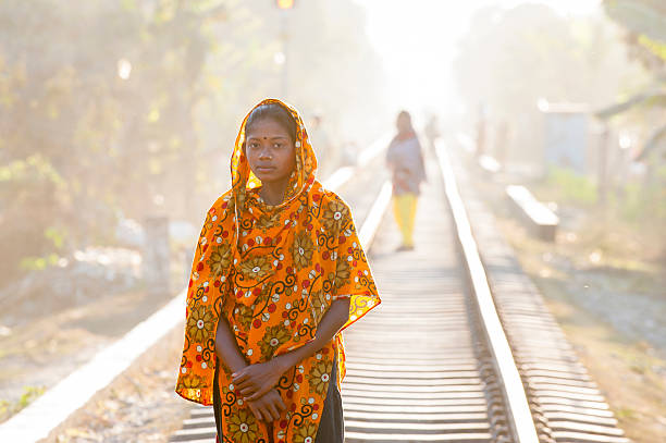 Bengali girl standing on the railway "Sylhet, Bangladesh - February 15, 2013: A bengali girl standing on the railway in a small village in Srimangal, a small town in Sylhet Division, Bangladesh." sylhet stock pictures, royalty-free photos & images