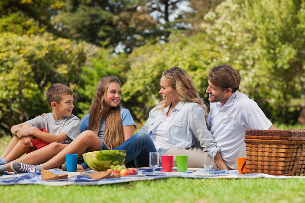 istock Parents and children posing together while having picnic 459262429