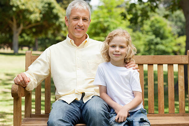 istock Man smiling as he sits with his son 459262743