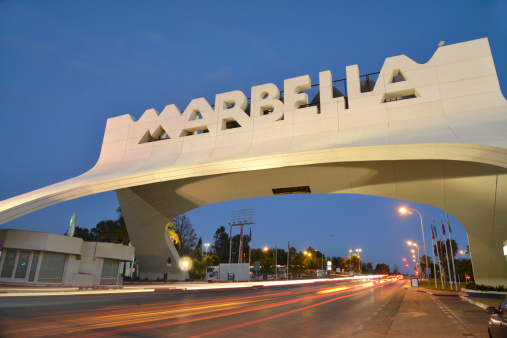 The famous Marbella arch at night. Showing light trails from the passing traffic.