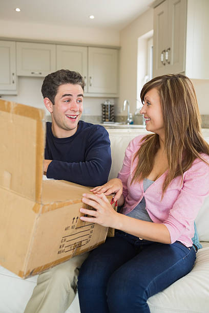 istock Woman and man opening box 459264131