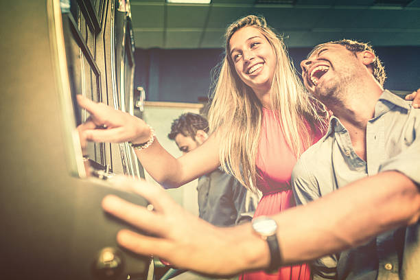 istock Couple playing slot machine at casino 459266661