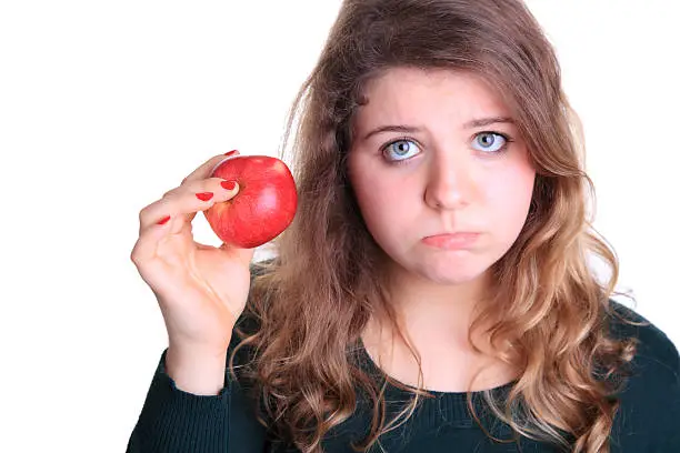 One young woman holding a red apple.