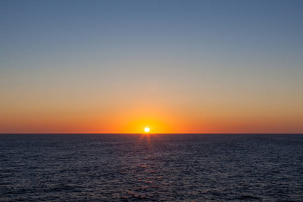 istock sun rise over the horizon at sea 459267623