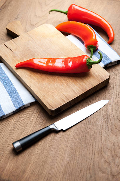 istock Old cutting board red pepper and knife 459268813