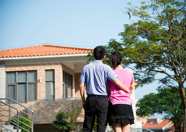 istock couple in front of new home 459269773