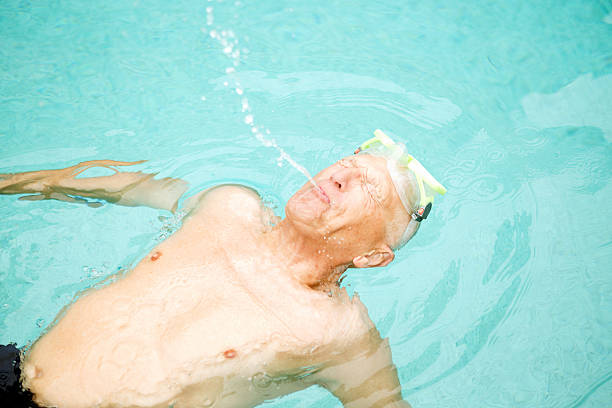 istock Senior Man Swimming and Playfully Spitting Water 459270723