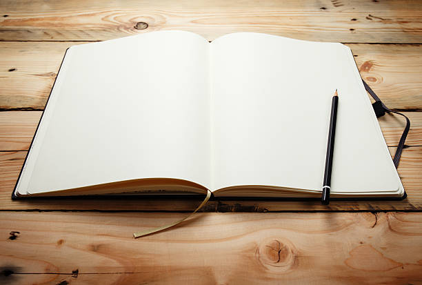 istock Blank notepad  with a pencil laying on old wooden table 459274561