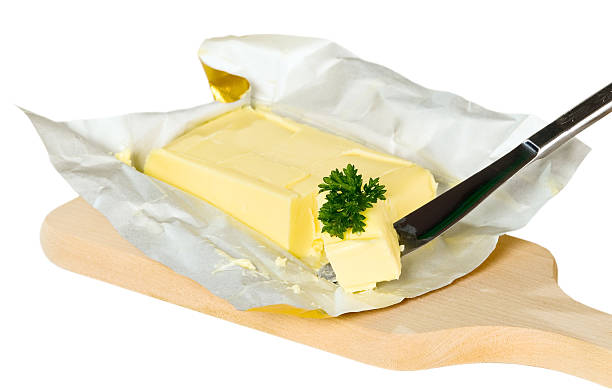 Yellow butter with paper package Yellow butter with paper package placed on isolated background butter margarine isolated portion stock pictures, royalty-free photos & images