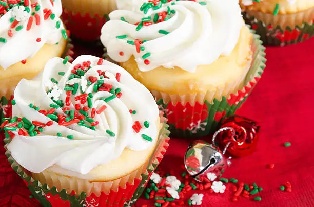 Photo of Holiday cupcakes with vanilla frosting, red and green sprinkles