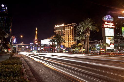 Las Vegas, USA - September 30, 2012: car trail along the Las Vegas strip at night.  Las Vegas Strip is a portion of of Las Vegas Boulevard South that houses most of the largest and most important entertainment buildings in Las Vegas--including casinos, hotels and resorts. One of the most visited streets in Las Vegas, the Strip offers not only top-class accommodations and gambling facilities, but it also offers street entertainment and great shopping.