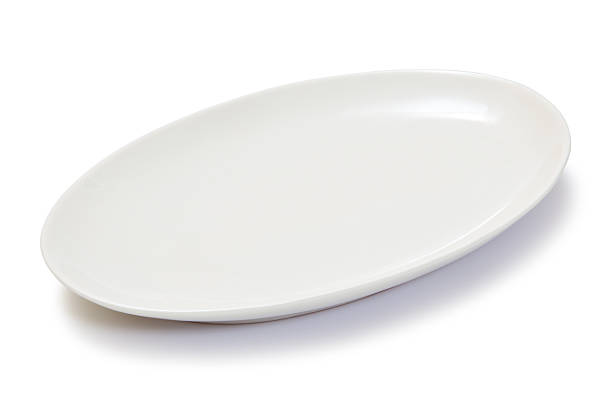 empty oval white plate stock photo