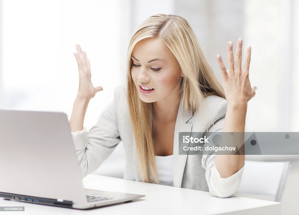 angry woman with laptop picture of angry businesswoman with laptop at work Computer Stock Photo