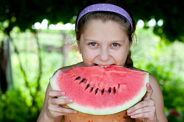 istock Little girl with watermelon 459291067