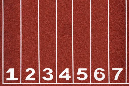 White number on red running track.