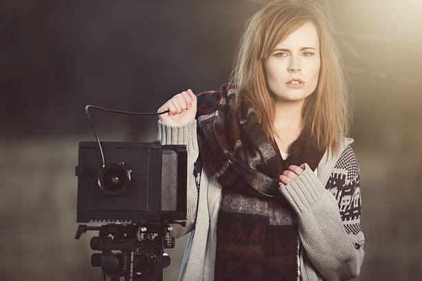 istock Young Woman with Vintage Bellow Camera 459292733